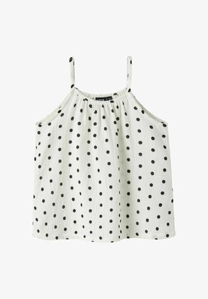 Blouse blanche sans manches avec fines bretelles et motif à pois noirs, à coupe ample et fluide.