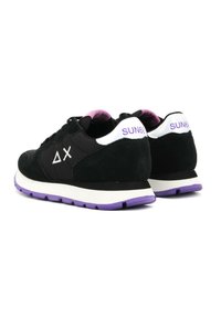 Black suede sneakers with purple accents and white heel tabs. Features logo detail on the side and a white midsole with a purple outsole.