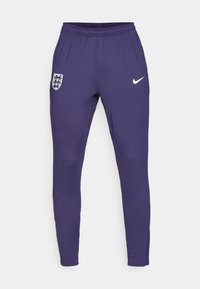 Lila Sporthosen von Nike mit einem elastischen Bund, tailliertem Schnitt, versehen mit dem England-Wappen und einem weißen Nike-Logo auf der Vorderseite.