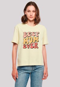 Light yellow, short-sleeved t-shirt featuring the text “BEST MOM EVER” in bold, colorful fonts with floral accents. Casual fit.