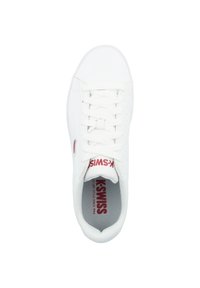 White leather sneaker with lace-up design, textured toe box, and red logo on tongue. Interior features a cushioned insole with mesh lining.