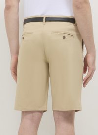 Beige shorts made of lightweight fabric, featuring a straight cut, back pockets with buttons, and a black leather belt.