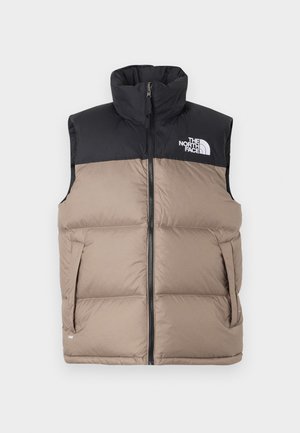 Chaleco acolchado negro y beige con cuello alto, cierre de cremallera y bolsillos laterales. Presenta el logo de The North Face en la parte superior izquierda.