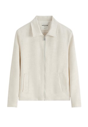 Veste crème avec une fermeture éclair devant, deux poches latérales, manches longues et col classique, en tissu texturé.