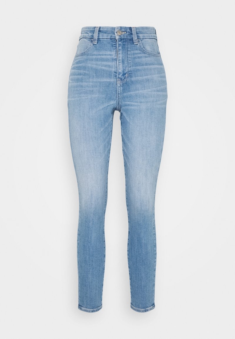 Ljusblå skinny jeans med hög midja, tillverkade av denimtyg. Har fem fickor, framknapp och en slät finish.