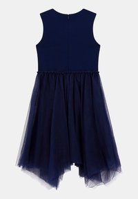 Navy dress with a fitted bodice and a tulle skirt. Sleeveless design, back zip closure, and layered texture. High-low hemline detail.