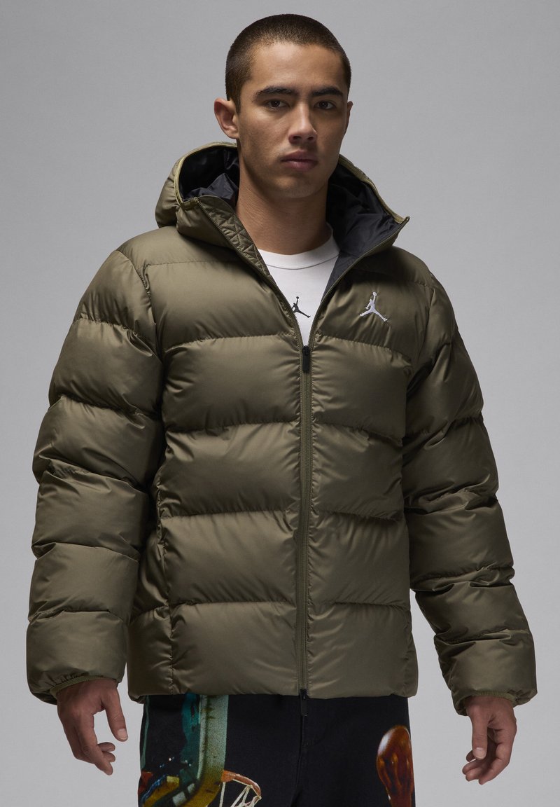 Olive green puffer jacket with a hood, featuring a zip closure and horizontal quilted design. Logo featured on the left chest.