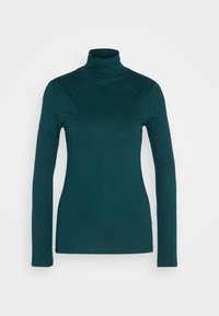 Tüllfarbene Langarm-Turtleneck-Bluse aus weichem, elastischem Stoff. Verfügt über ein figurschmeichelndes Design und einen gerippten Kragen. Glatte Oberfläche über die gesamte Textur.