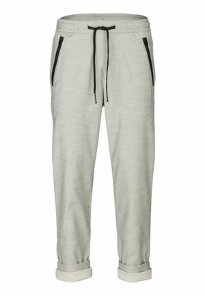 Helle graue Jogginghosen aus weichem Stoff, mit schwarzen Reißverschlusstaschen und einem Kordelzugbund, sowie umgeschlagenen Bündchen am Knöchel.