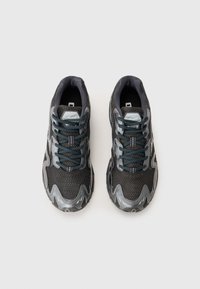 Dark gray athletic shoes with mesh fabric upper, padded collar, tonal laces, and contrasting rubber sole featuring wave-like design.