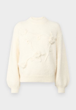 Maglione color crema con collo alto, maniche a palloncino e ricami floreali testurizzati sul davanti. Materiale morbido e vellutato.