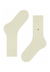 Beżowe skarpetki prążkowane o gładkiej strukturze, wzmocnionym pięcie i palcach oraz małej dekoracyjnej szarej kropce z boku.