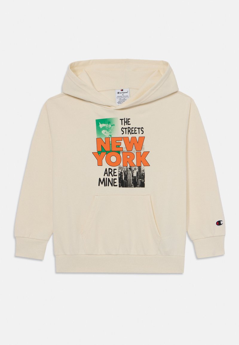 Sudadera color crema con un gráfico frontal que incluye el texto "LAS CALLES DE NUEVA YORK SON MÍAS". Incluye un bolsillo tipo canguro y puños de canalé. Logo en la manga.