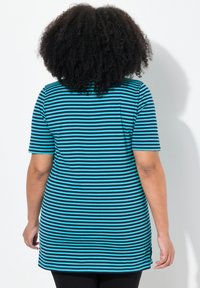 Túnica a rayas con mangas cortas; presenta rayas alternas en turquesa y negro. Tela suave, corte relajado y aberturas laterales en el dobladillo.