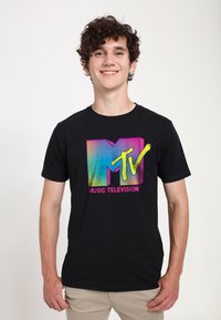 Black cotton t-shirt featuring a colorful retro MTV logo with stripes and yellow accents. The design is centered on the front.
