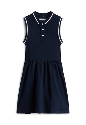 Marineblå ermeløs kjole med krage, treknappet stolpe og kontrasterende hvit kant på kragen og armhulene; innsnevret skjørt.