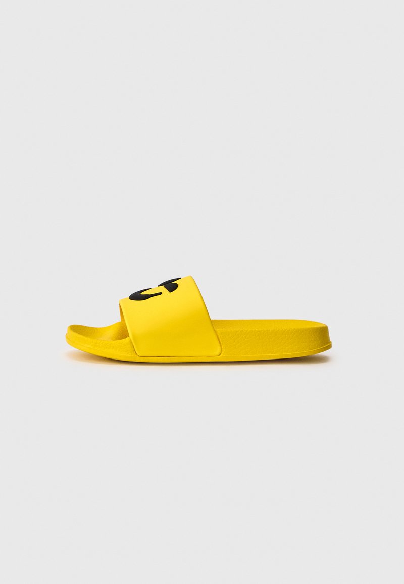 Yellow slide sandal made of rubber with a wide strap featuring a black graphic. Contoured footbed and textured sole for grip.