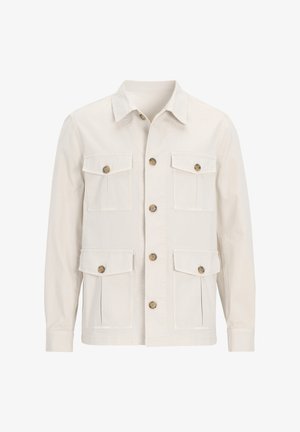Beige canvas jacket with a collar, six pockets, and brown buttons. Features a straight cut and long sleeves. Textured fabric design.