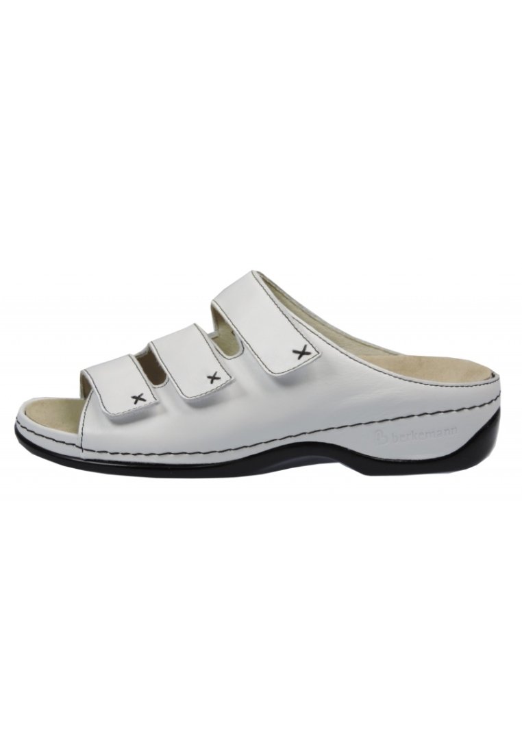 White leather slip-on sandals with three adjustable straps, black accents, and a contoured footbed. Features stitched detailing and open toe.