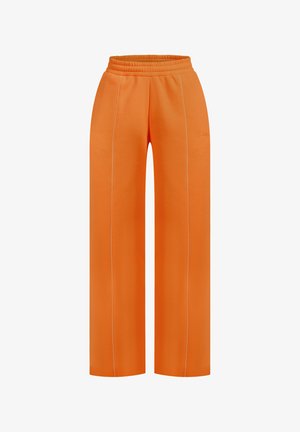 Orangene weit geschnittene Sweatpants mit elastischem Bund, die über weiße Nähte an den Seiten und eine glatte Textur verfügen.