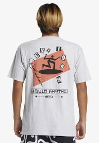 Gray short-sleeve t-shirt featuring a graphic design with a silhouette of a surfer on an orange geometric background and text.