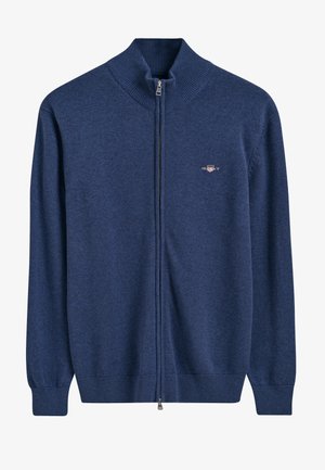 Maglione zip-up blu navy con colletto alto a coste, realizzato in morbido tessuto a maglia, con un piccolo logo sul lato sinistro del petto e polsini a coste.