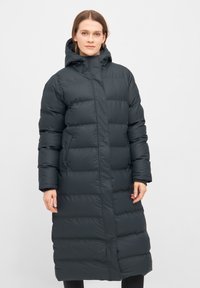 Dikke zwarte lange jas met capuchon, voorzien van een geborduurd ontwerp, voorrits en twee zijzakken. Soepele textuur en lichtgewicht materiaal.