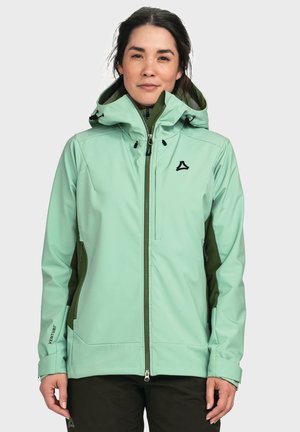 Hellgrüne wasserdichte Jacke mit Kapuze, schwarzen Akzenten, Reißverschlusstaschen und verstellbaren Bündchen. Hat eine schlanke Passform und eine weiche Textur.