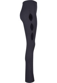 Melni svītraini legingi ar izgriezumiem gar malu. Izgatavoti no elastīga materiāla, pieguļoša fasona un pilna garuma.
