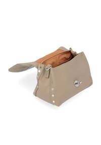 Borsa a mano in pelle beige con superficie testurizzata, hardware silver e dettagli con borchie. L'apertura superiore rivela un rivestimento interno arancione.
