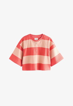 Red and cream cropped t-shirt with wide sleeves, featuring horizontal stripes and a buttoned neck. Made of soft fabric. Round neckline.