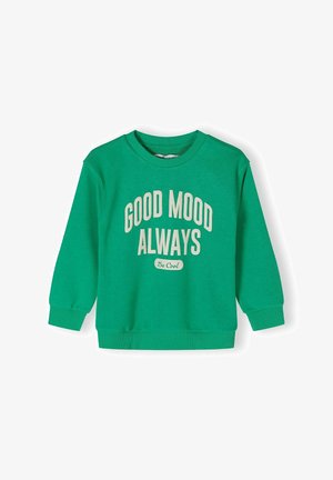 Zeleni bombažni sweatshirt z dolgimi rokavi, rebrastimi manšetami in ovratnikom, na sprednji strani pa je v beli barvi natisnjeno 'DOBRO RAZPoloženJE VEDNO'.