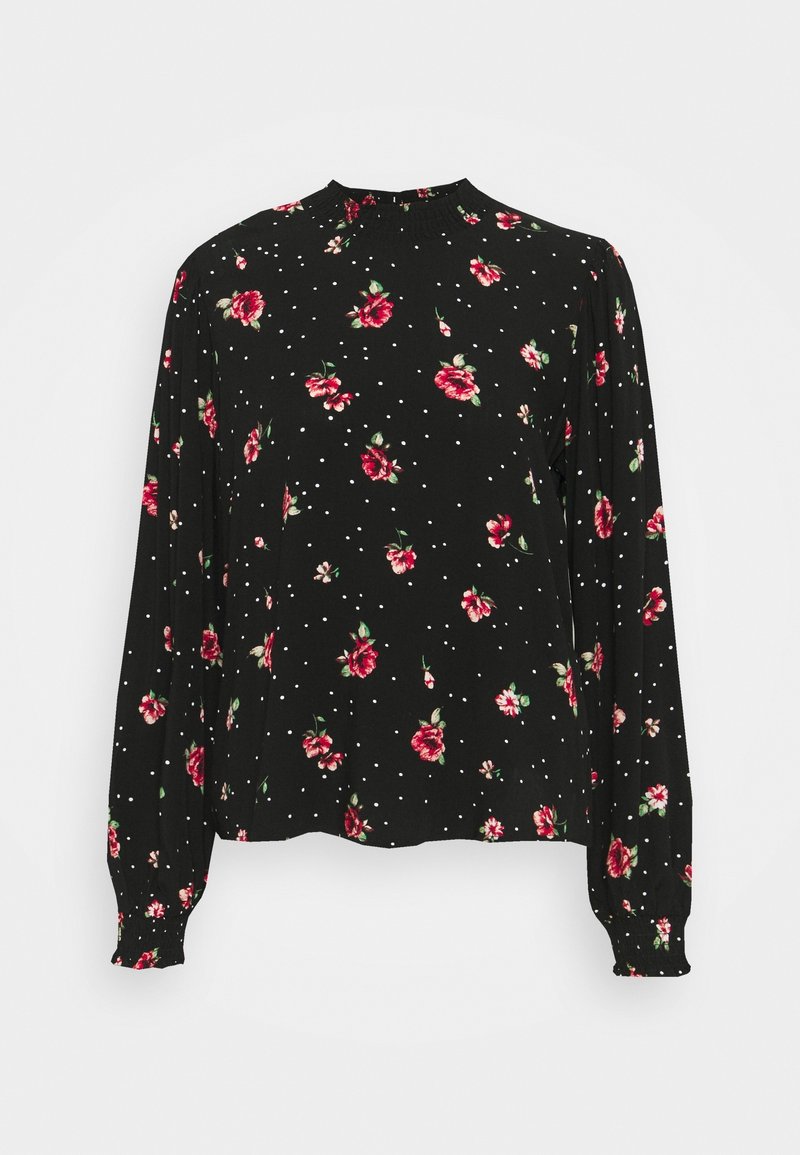 Blouse noire à manches longues avec un motif floral rouge et rose et des pois blancs, col montant et poignets froncés.