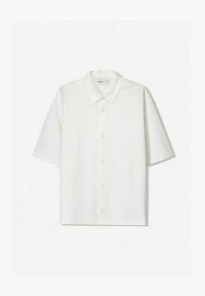 White short-sleeve shirt made from textured fabric. Features a collared neckline and buttons down the front. Simple, clean design.