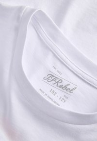Λευκή λαιμόκοψη T-shirt με ορατή εσωτερική ετικέτα που εμφανίζει την μάρκα JJRebel, μέγεθος 152-12Y και το κείμενο "Made in Bangladesh".