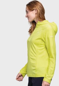 Hoodie mit langen Ärmeln in leuchtendem Limettengrün mit glatter Textur, ausgestattet mit einem teilweisen Frontreißverschluss und einem dezenten geometrischen Muster an den Seiten.