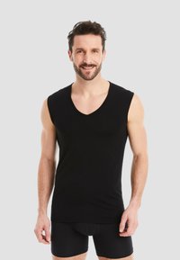 Black sleeveless v-neck tank top in a soft, stretchy fabric. Features a fitted design with no patterns and smooth edges.