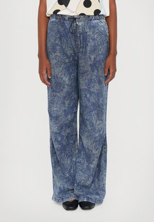 Blue patterned wide-leg pants made of denim, featuring an elastic waistband with a drawstring. The fabric has a textured leaf design.