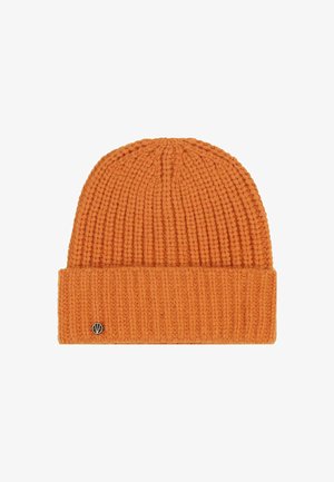 Orange ribbed knit beanie with folded cuff and small round metal logo pin on the cuff's left side.