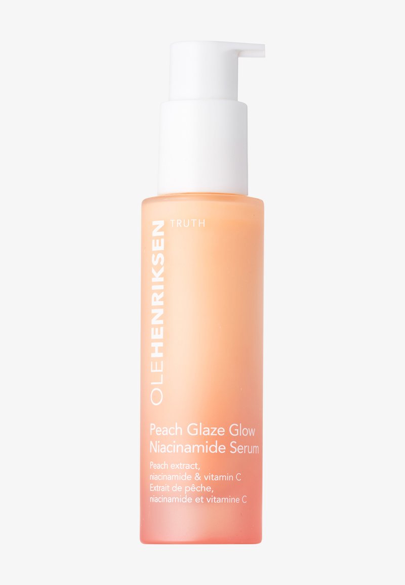 Peach Glaze Glow Niacinamid-Serum in einer mattierten Glasflasche. Farbverlauf in Orange mit weißem Pumpkopf und Text, enthält Pfirsich- und Vitamin C-Zutaten.