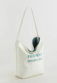White, textured faux leather tote bag with a curved opening and a teal interior. "FRIENDLY DOUBLE BAG" printed in bold teal letters.