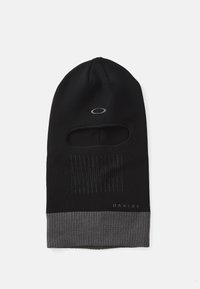 Black knit balaclava with a grey ribbed bottom, featuring a front opening and vertical stitch accents. Logo at the base.