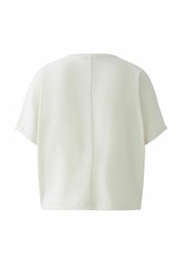 Kurzärmliges, cropped Top aus cremefarbener Stoff mit glatter Textur; verfügt über eine zentrale Naht im Rücken und umgeschlagene Ärmel.