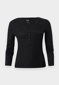 Top nero a maniche lunghe con scollo a V e pattina con cinque bottoni. Realizzato in tessuto morbido e leggero con una forma aderente.