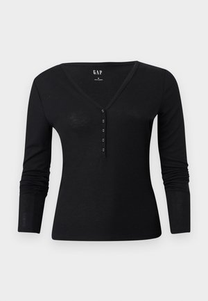 Zwart top met lange mouwen, een V-hals en een knoopsluiting met vijf knopen. Gemaakt van een zachte, lichtgewicht stof met een aansluitende pasvorm.
