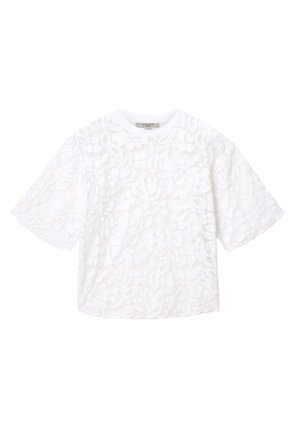 White short-sleeve blouse with floral lace overlay and round neckline, featuring a scalloped hem and wide sleeves.
