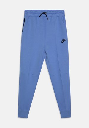 Light blue Nike sweatpants with elastic waistband, drawstring, side zip pockets, and black logo. Smooth fabric, tapered design.