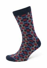 Gemusterte Socke mit einem geometrischen Design in Rot, Blau und Beige. Aus weichem Material mit einem navyblauen Rippbündchen und verstärktem Zehenbereich.