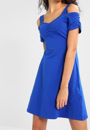 Niebieska, krótko rękawowa sukienka z kwadratowym dekoltem i marszczonymi detalami na ramionach. Kształt A-linii z gładkiego, elastycznego materiału.