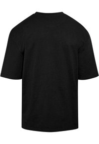 Black cotton T-shirt featuring a relaxed fit, short sleeves, and a classic crew neckline. Plain design with no visible graphics or patterns.